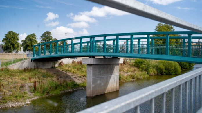 person-walking-over-new-lawson-footbridge_places-for-everyone_hawick-active-travel-network_hawickatn-9583_credit-michael-kelly-sustrans